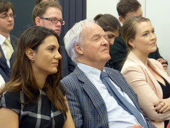 The audience listens attentively