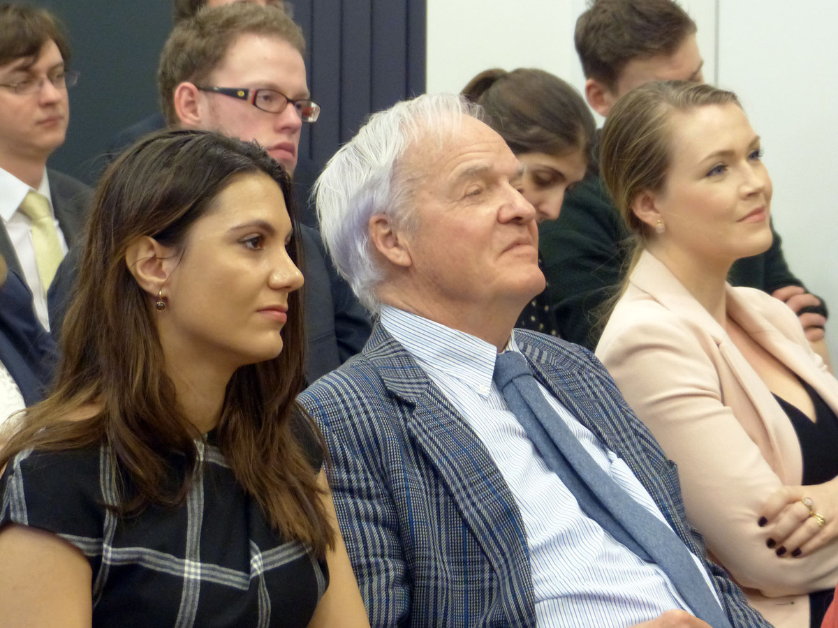 The audience listens attentively