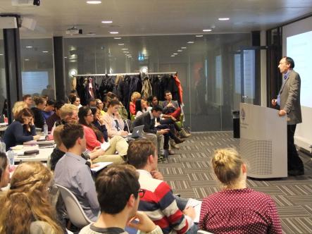 The audience listens attentively to Marc Chavannes 