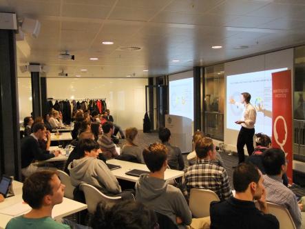 The audience listens attentively to Ulrich Mans