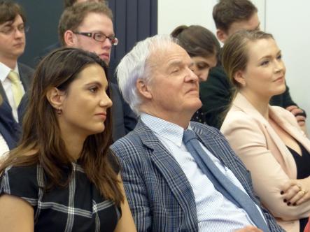 The audience listens attentively