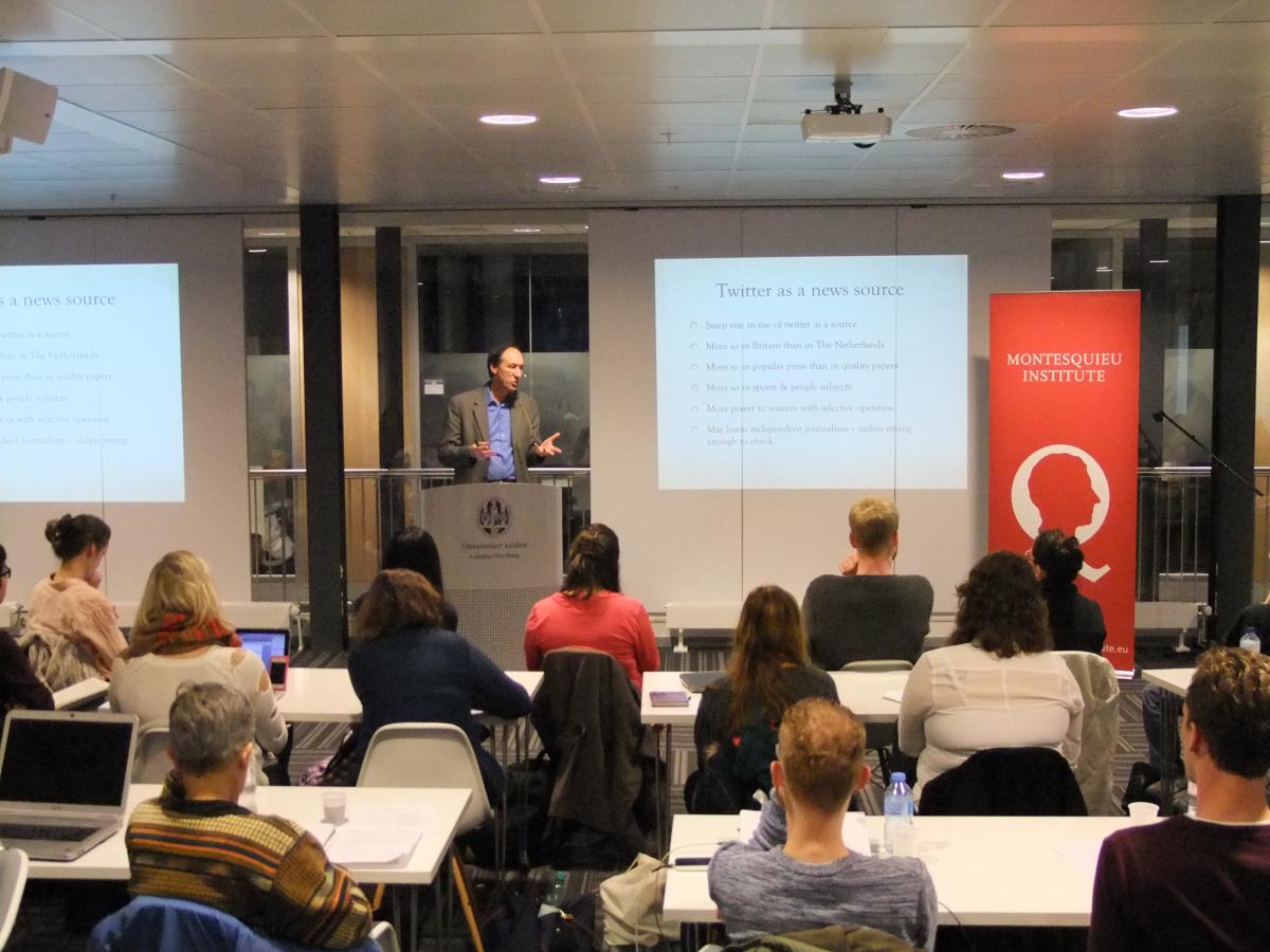 The audience listens attentively to Marc Chavannes 