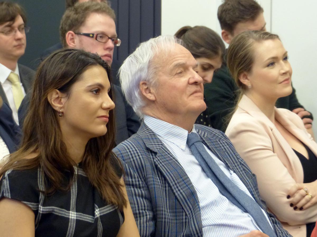 The audience listens attentively